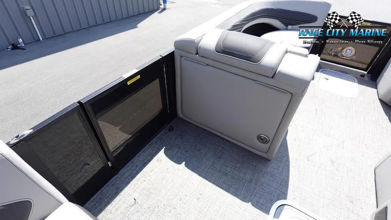 Slide: The Image of 2025 Barletta X23U boat interior with gray seating and storage compartment. - 19