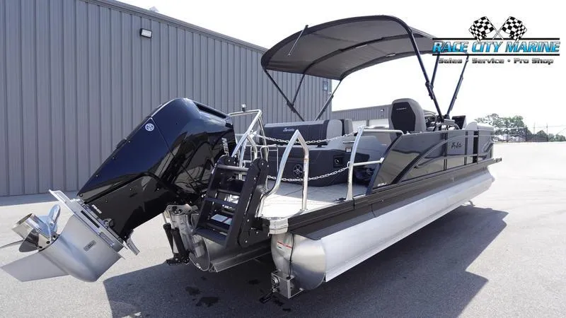 Slide: The Image of 2025 Barletta X23U pontoon boat with canopy and outboard motor at Race City Marine. - 2