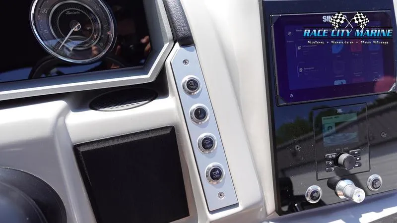 Slide: The Image of 2025 Barletta X23U dashboard with controls and Race City Marine branding. - 27