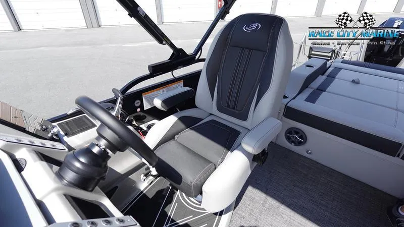 Slide: The Image of 2025 Barletta X23U boat interior with sleek captain's chair and modern dashboard. - 29