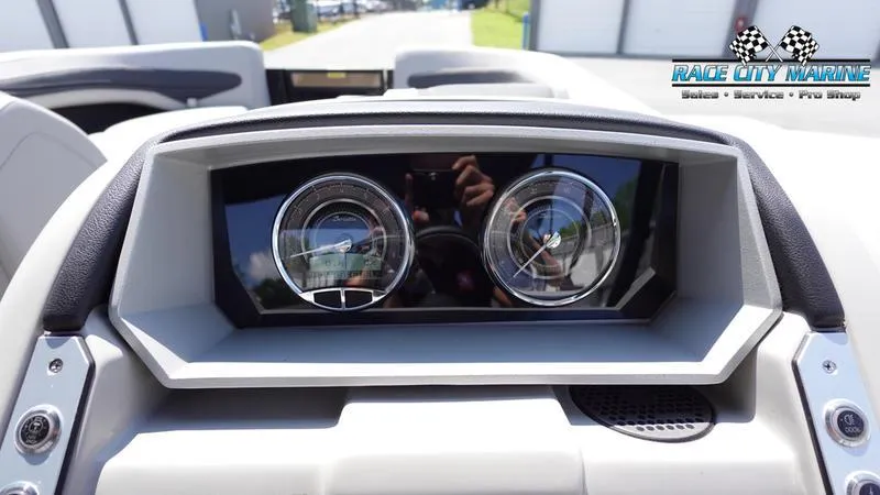 Slide: The Image of 2025 Barletta X23U dashboard with dual gauges, Race City Marine logo. - 31