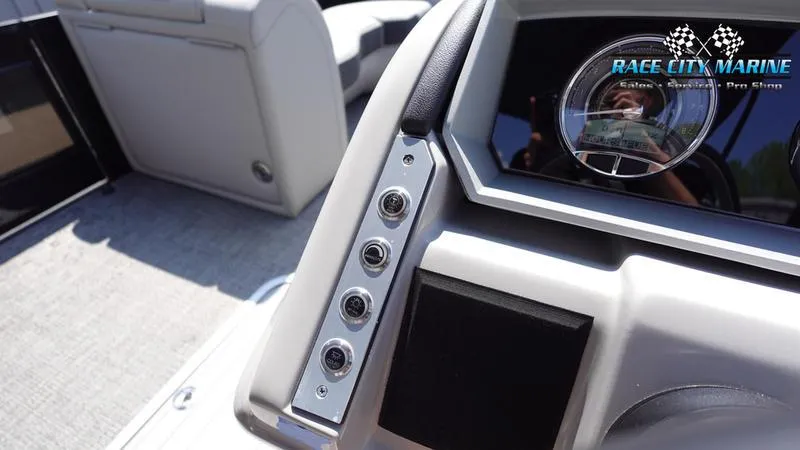 Slide: The Image of 2025 Barletta X23U boat dashboard with control panel and Race City Marine logo. - 34