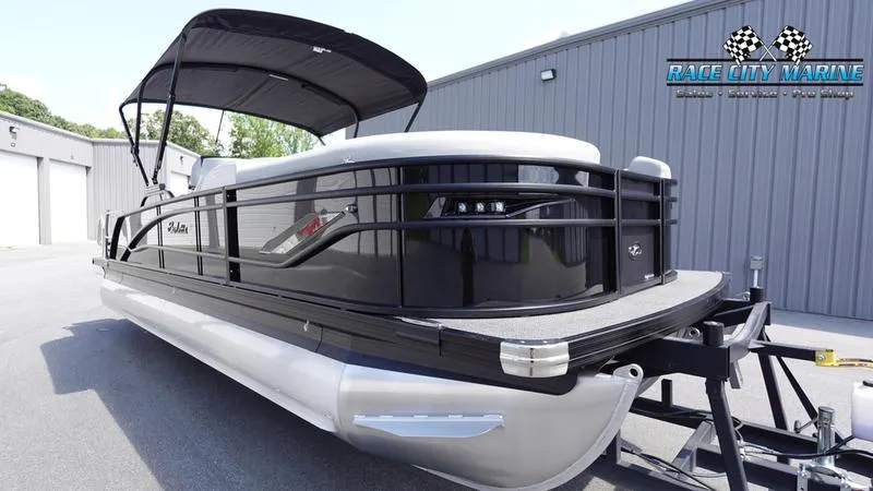 Slide: The Image of 2025 Barletta X23U pontoon boat with canopy, parked on trailer. - 4
