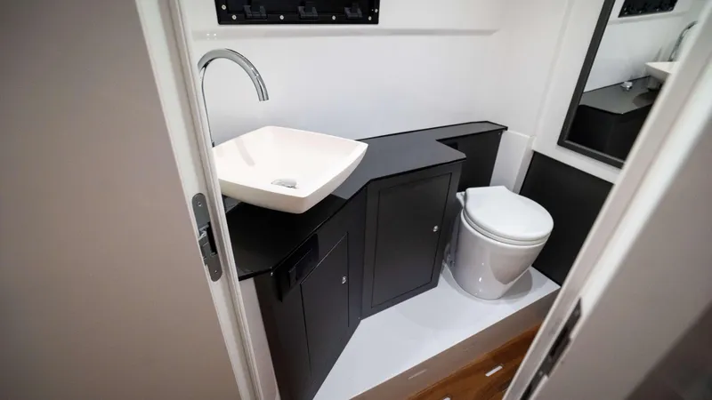 Slide: The Image of Modern bathroom in 2025 Pirelli TecnoRib 42 OB boat, featuring sleek sink and toilet. - 22