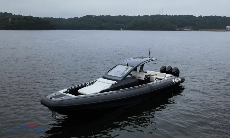 Slide: The Image of 2025 Pirelli TecnoRib 42 OB boat on calm lake waters. - 3