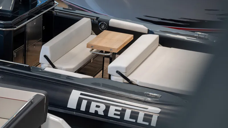 Slide: The Image of 2025 Pirelli TecnoRib 42 OB luxury boat interior with seating and table. - 6