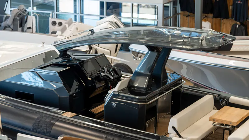 Slide: The Image of 2025 Pirelli TecnoRib 42 OB luxury boat interior with modern dashboard and seating. - 7