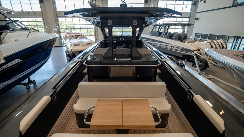 Slide: The Image of 2025 Pirelli TecnoRib 42 OB luxury boat interior with seating and table in showroom. - 8