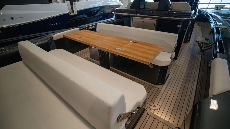 Slide: The Image of Luxurious interior of 2025 Pirelli TecnoRib 42 OB with sleek seating and wooden table. - 9