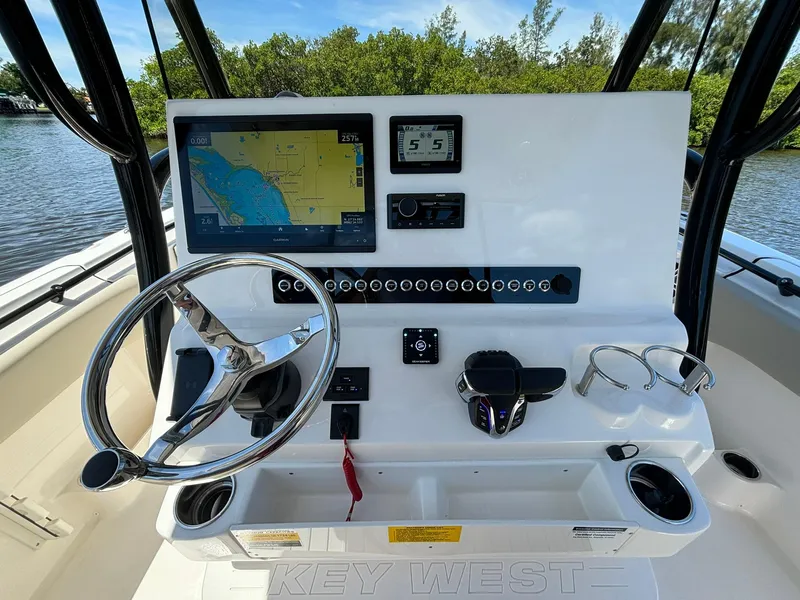 Slide: The Image of 2025 Key West 263 FS boat dashboard with navigation screen and controls. - 12