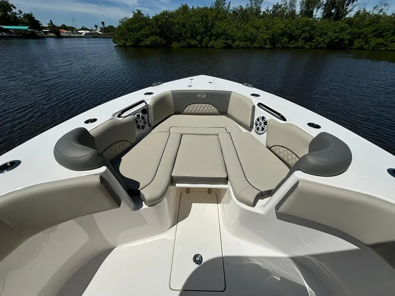 Slide: The Image of 2025 Key West 263 FS boat with spacious seating on calm water. - 14