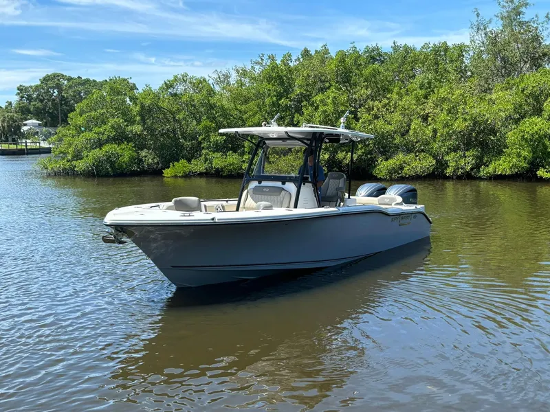 Slide: The Image of 2025 Key West 263 FS boat on calm water near lush greenery. - 3