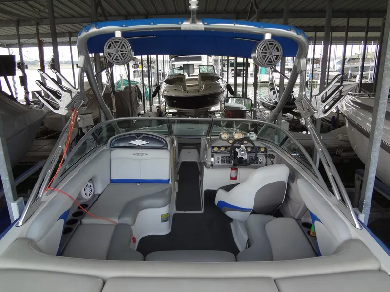 Slide: The Image of 2004 MasterCraft X-Star boat interior with seating and control panel in marina. - 11