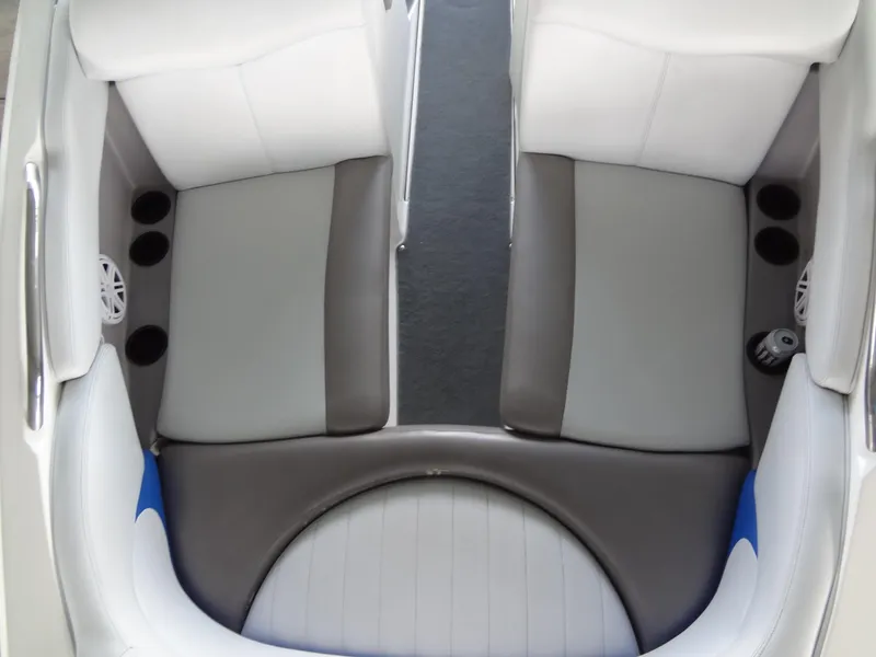 Slide: The Image of 2004 MasterCraft X-Star boat interior with gray and white seating, cup holders, and speaker. - 17