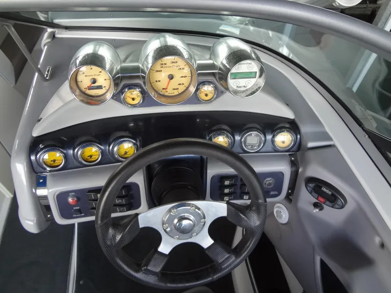 Slide: The Image of 2004 MasterCraft X-Star dashboard with gauges and steering wheel. - 19