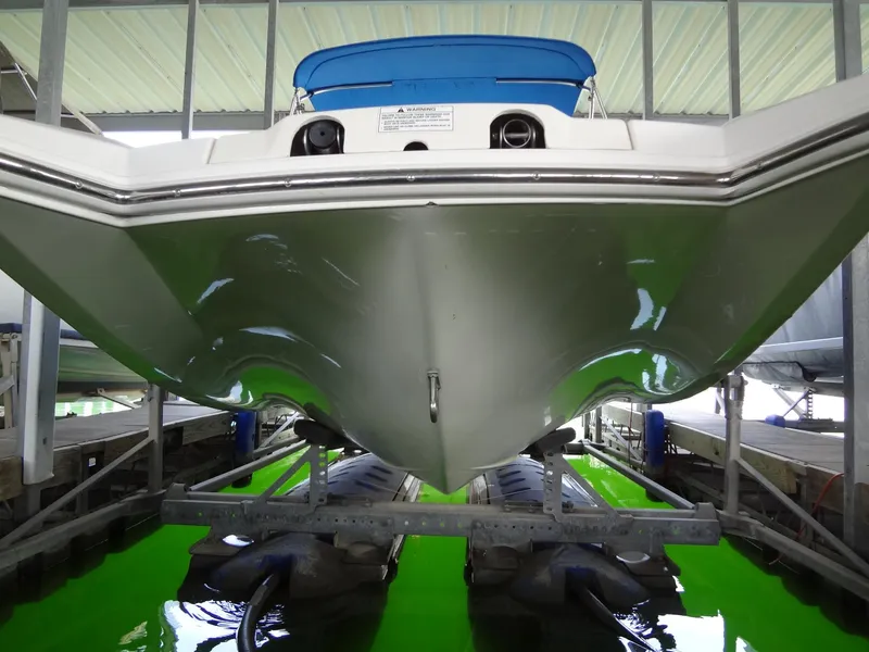 Slide: The Image of 2004 MasterCraft X-Star boat on lift, viewed from below, in a covered dock. - 3