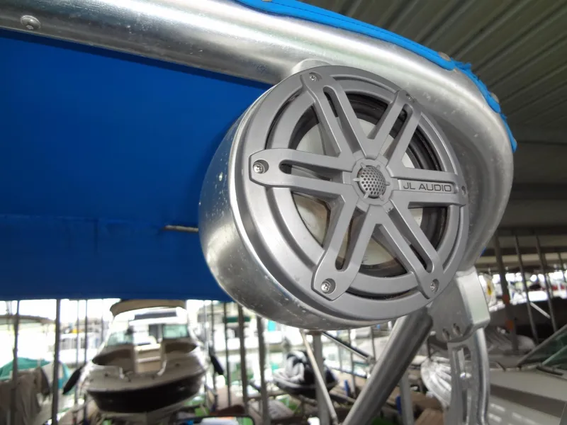Slide: The Image of JL Audio speaker on 2004 MasterCraft X-Star boat with blue canopy. - 30