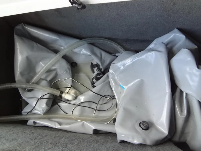 Slide: The Image of 2004 MasterCraft X-Star ballast bag with hoses in storage compartment. - 34