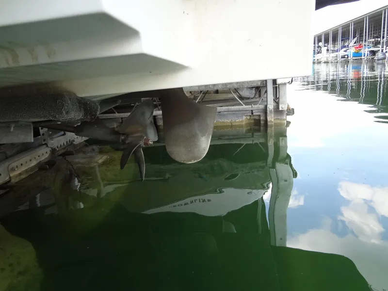 Slide: The Image of 2004 MasterCraft X-Star boat propeller and rudder in marina water. - 36