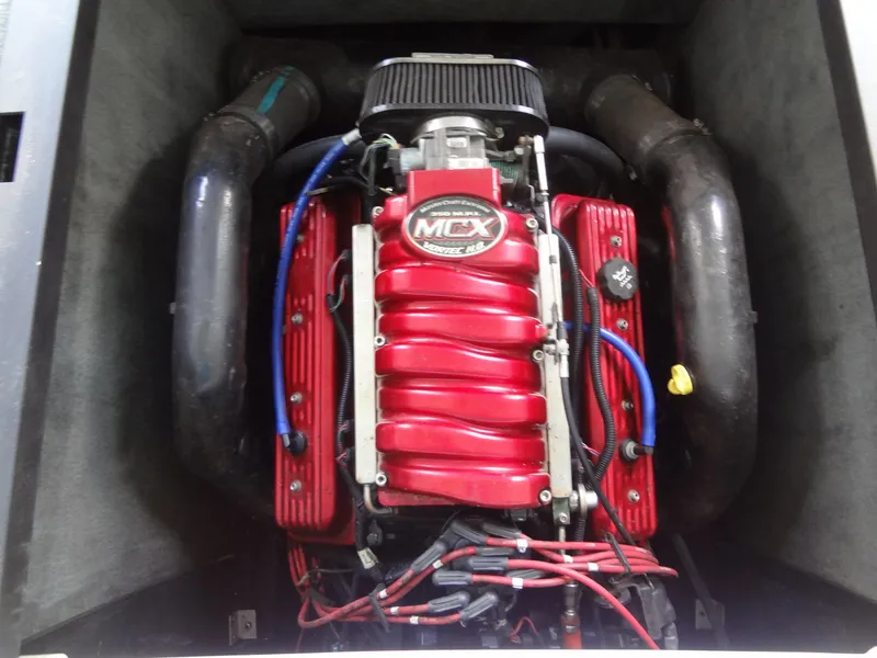 Slide: The Image of 2004 MasterCraft X-Star engine with red cover and MCX logo. - 38