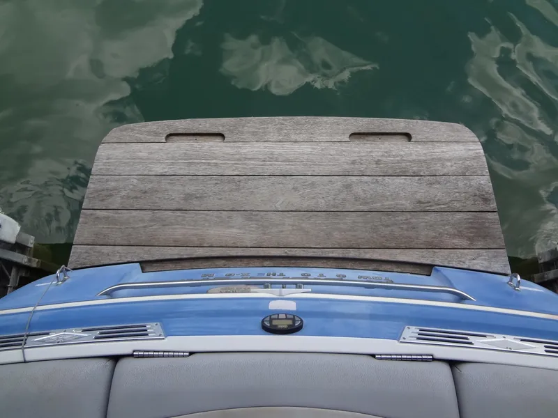 Slide: The Image of 2004 MasterCraft X-Star boat with wooden swim platform on calm water. - 9