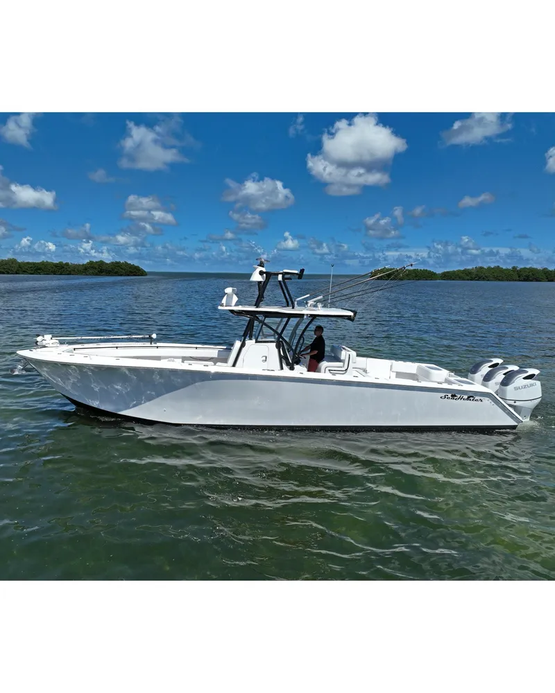 Slide: The Image of 2018 SeaHunter 39 Tournament boat on calm water under blue sky. - 10