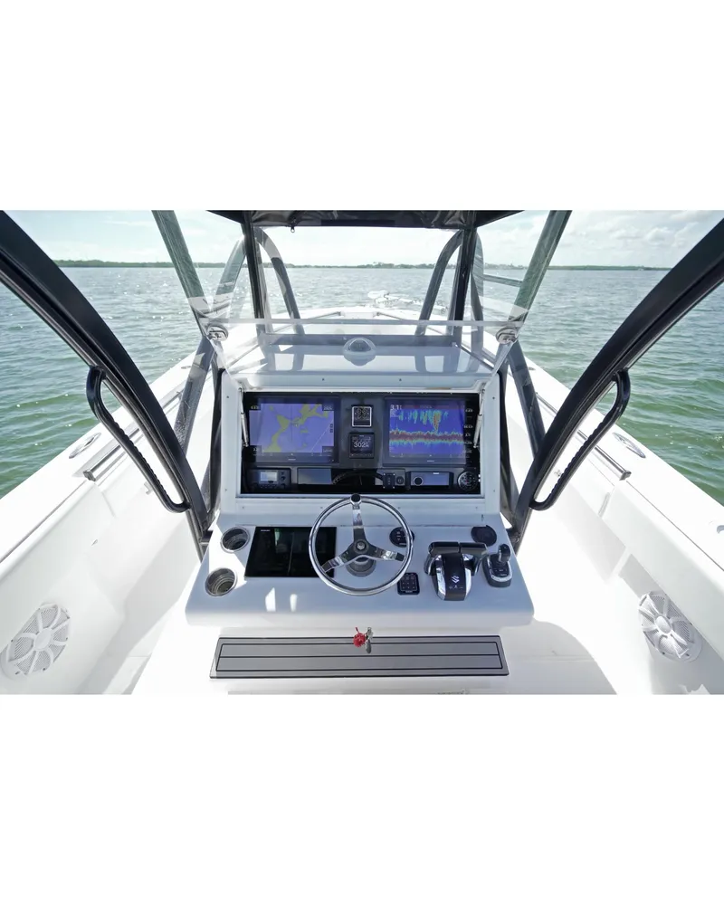 Slide: The Image of 2018 SeaHunter 39 Tournament boat dashboard with navigation screens on open water. - 12
