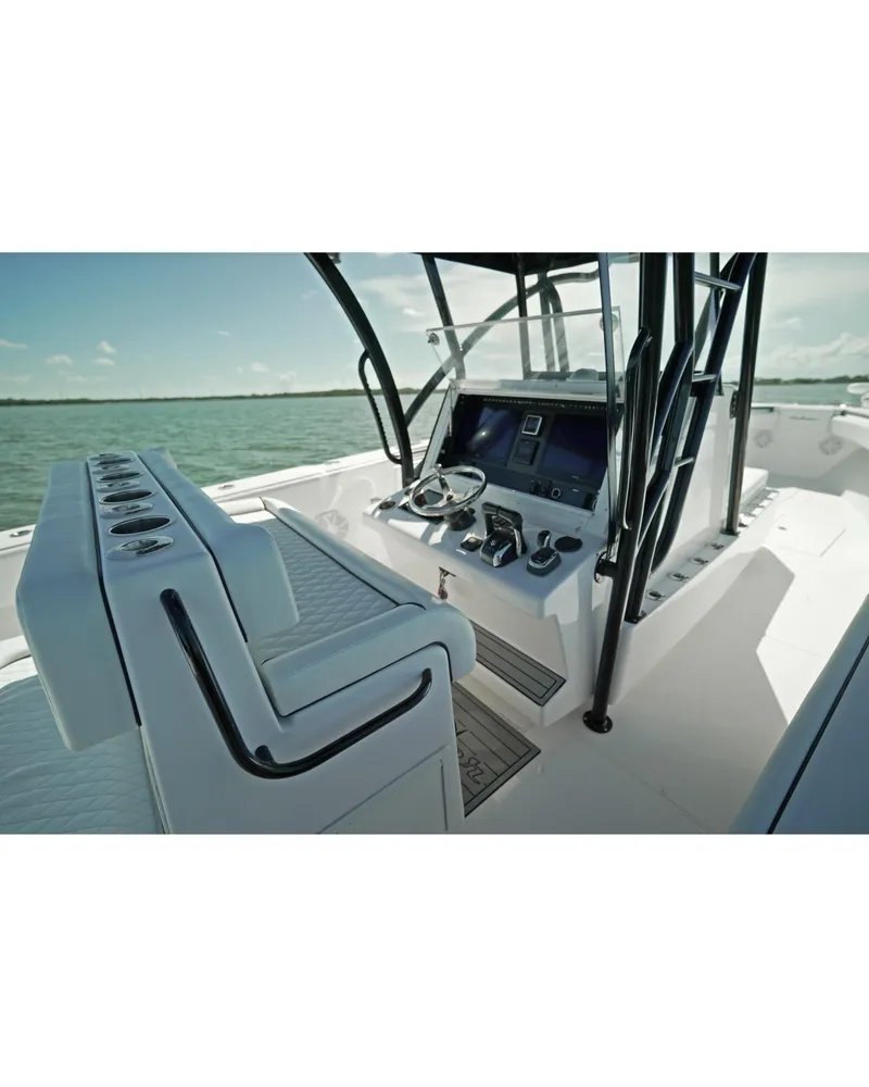 Slide: The Image of 2018 SeaHunter 39 Tournament boat interior with helm and seating, on open water. - 14