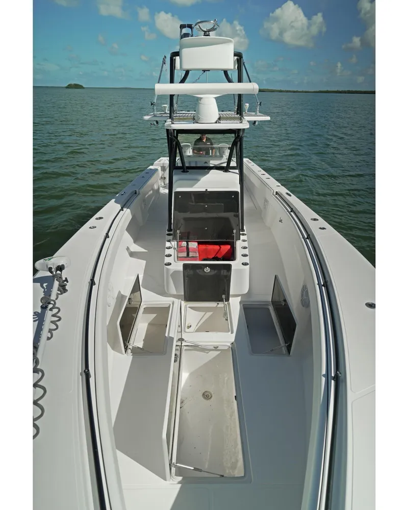 Slide: The Image of 2018 SeaHunter 39 Tournament boat on calm water, showcasing spacious deck and storage. - 19