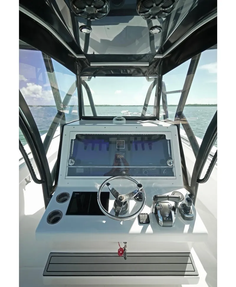 Slide: The Image of 2018 SeaHunter 39 Tournament boat cockpit with steering wheel and controls. - 23