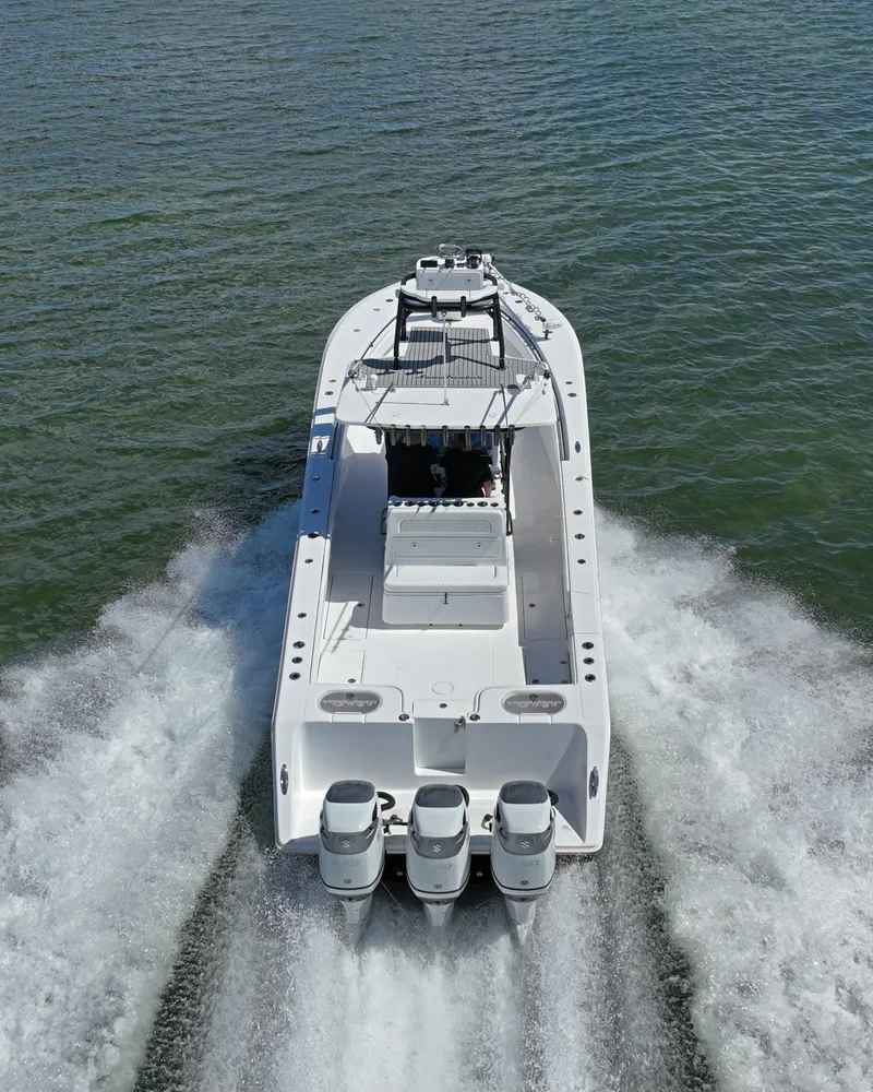 Slide: The Image of 2018 SeaHunter 39 Tournament boat cruising on open water, rear view. - 3