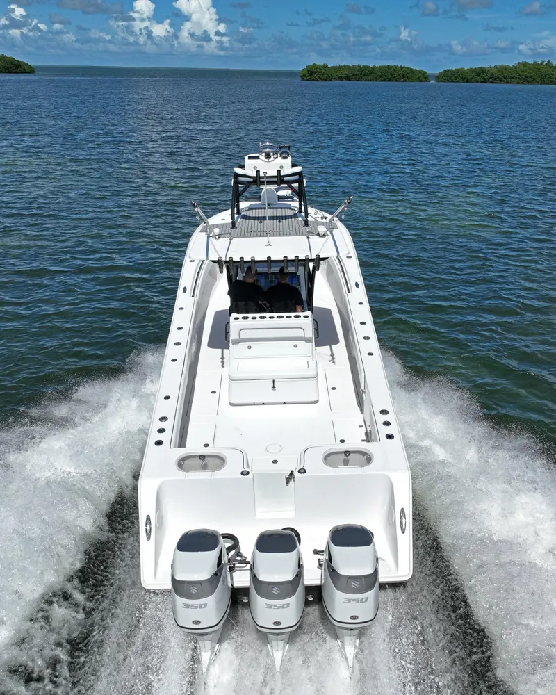 Slide: The Image of 2018 SeaHunter 39 Tournament boat cruising on open water with triple engines. - 8