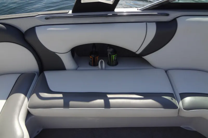 Slide: The Image of 2022 Sanger V237 S boat interior with cushioned seating and cup holders. - 14