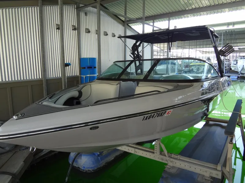 Slide: The Image of 2022 Sanger V237 S boat in a covered dock, sleek design, ready for water adventures. - 22