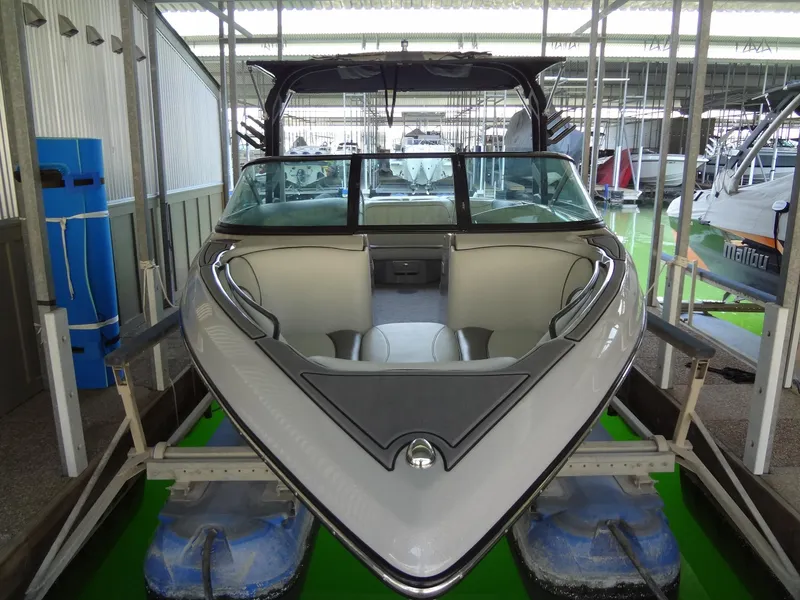 Slide: The Image of 2022 Sanger V237 S boat in marina, front view, sleek design. - 23