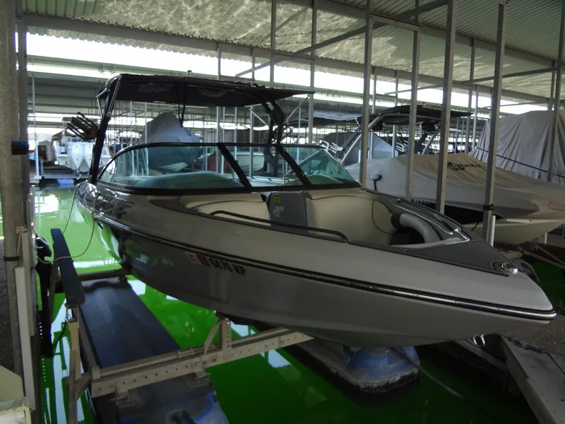 Slide: The Image of 2022 Sanger V237 S boat docked in covered marina. - 25