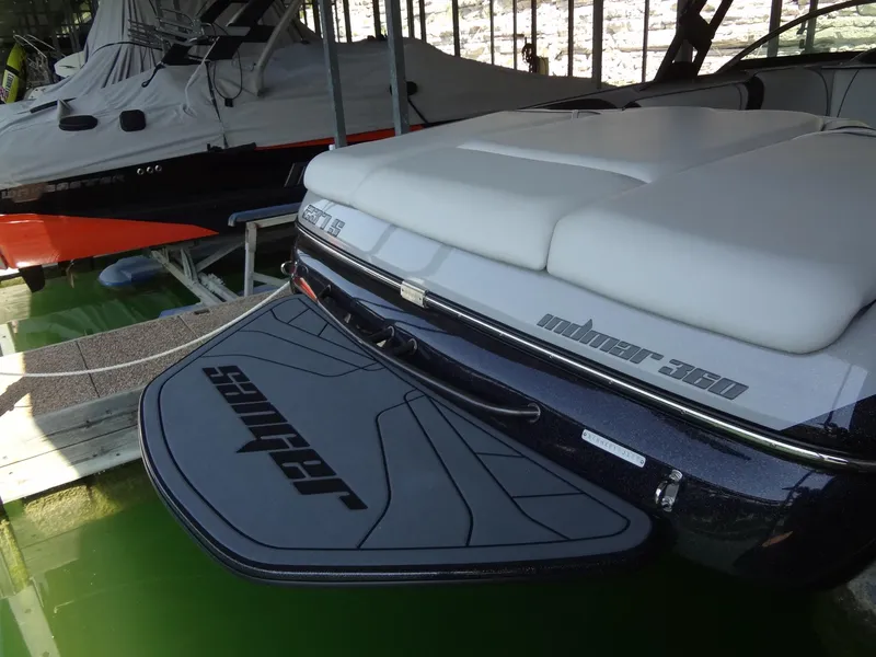 Slide: The Image of 2022 Sanger V237 S boat docked, featuring sleek design and swim platform. - 29