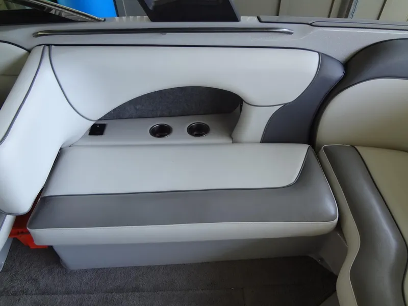 Slide: The Image of 2022 Sanger V237 S boat interior with gray and white seating and cup holders. - 35