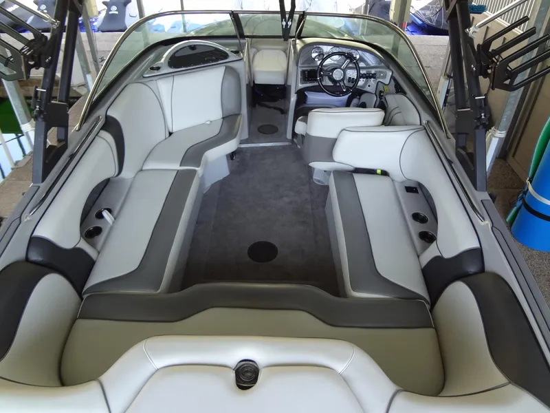 Slide: The Image of 2022 Sanger V237 S boat interior with gray and white seating, modern dashboard. - 42