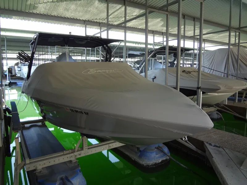 Slide: The Image of 2022 Sanger V237 S boat covered in a marina, stored on a lift. - 51