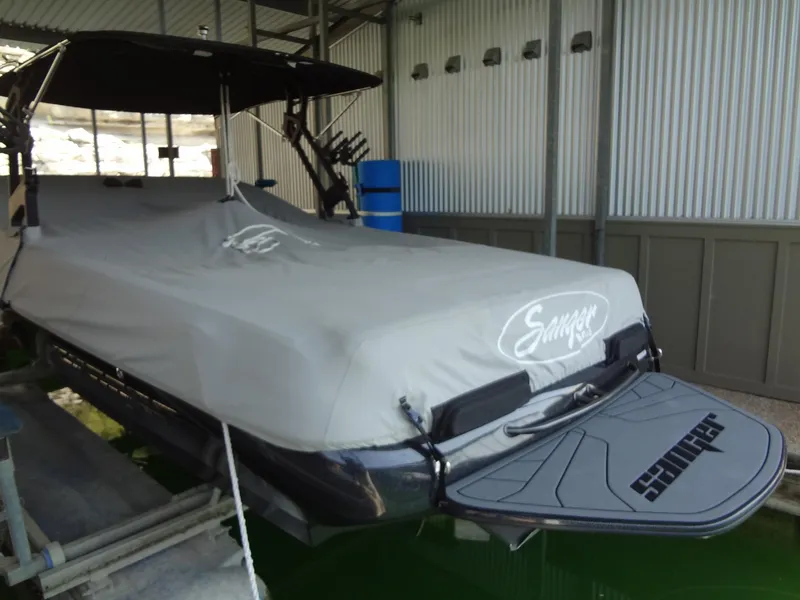 Slide: The Image of 2022 Sanger V237 S boat covered in storage, docked indoors. - 54
