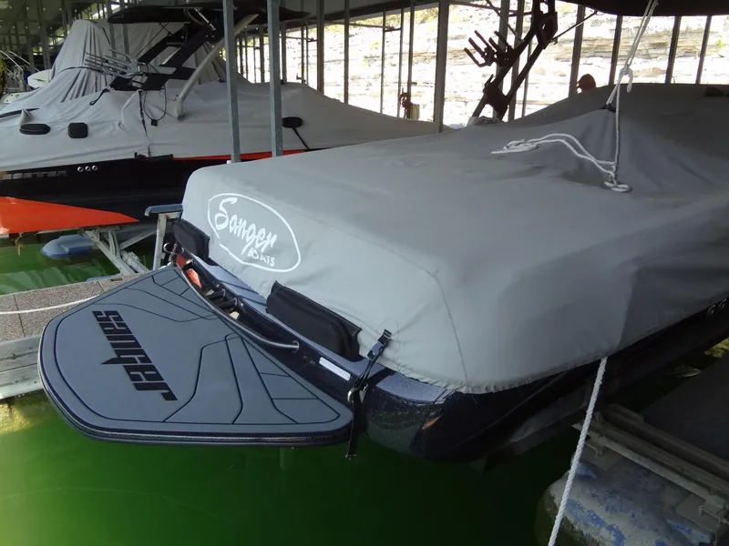 Slide: The Image of 2022 Sanger V237 S boat covered in a dock, rear view. - 55