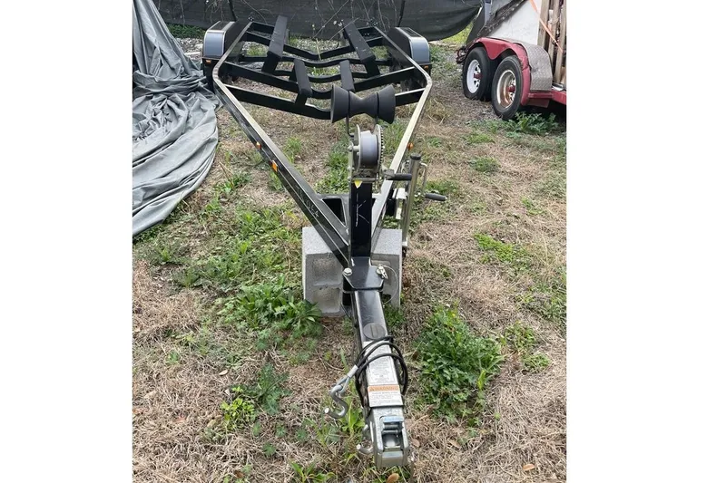 Slide: The Image of Trailer for 2022 Sanger V237 S boat on grassy area. - 56