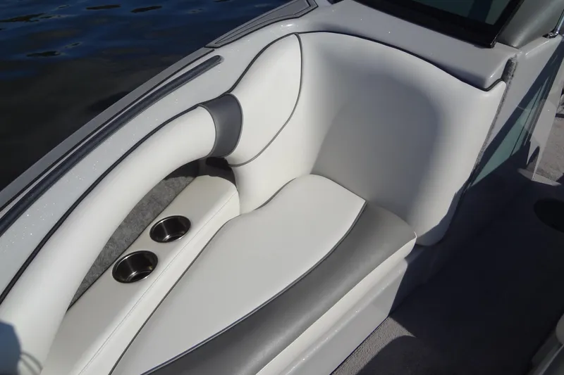 Slide: The Image of 2022 Sanger V237 S boat interior with white cushioned seating and cup holders. - 6