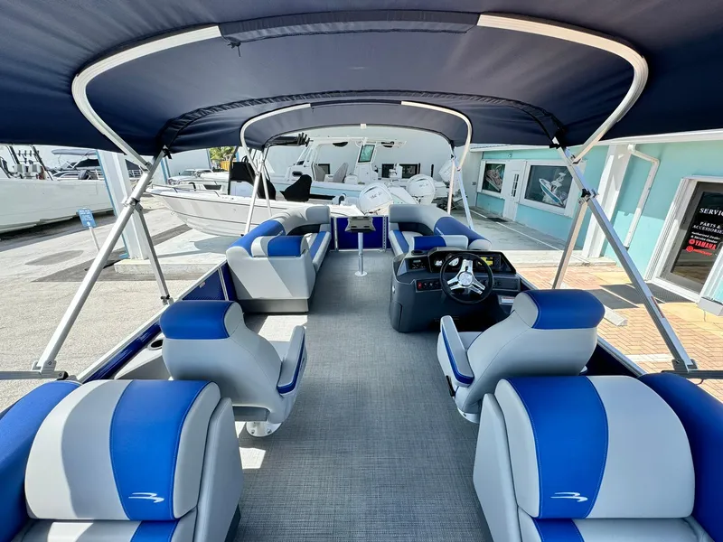 Slide: The Image of 2024 Bennington 22 SSR-SPS pontoon boat interior with blue and gray seating. - 12