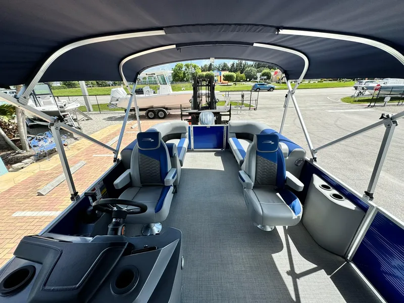 Slide: The Image of 2024 Bennington 22 SSR-SPS pontoon boat interior with seating and canopy. - 14