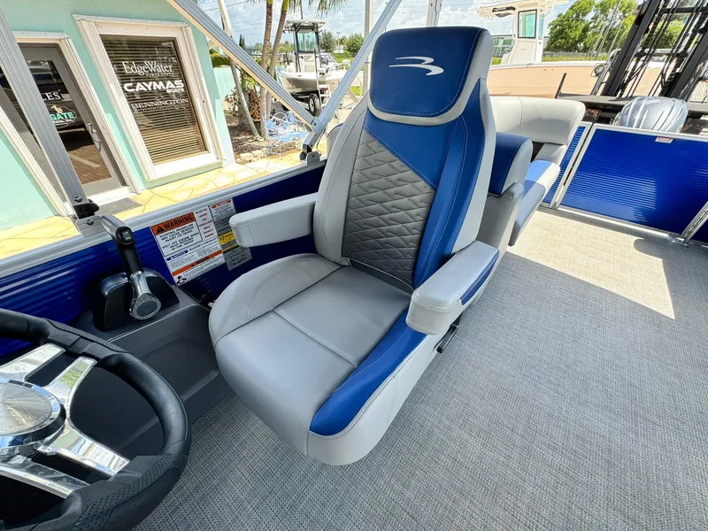 Slide: The Image of 2024 Bennington 22 SSR-SPS boat interior with blue and gray captain's chair. - 16