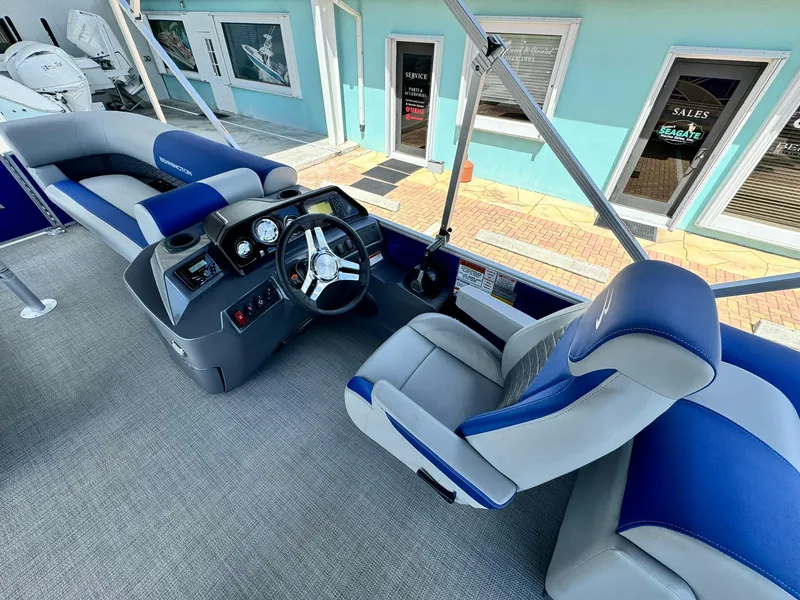 Slide: The Image of 2024 Bennington 22 SSR-SPS boat interior with blue and gray seating and modern dashboard. - 17