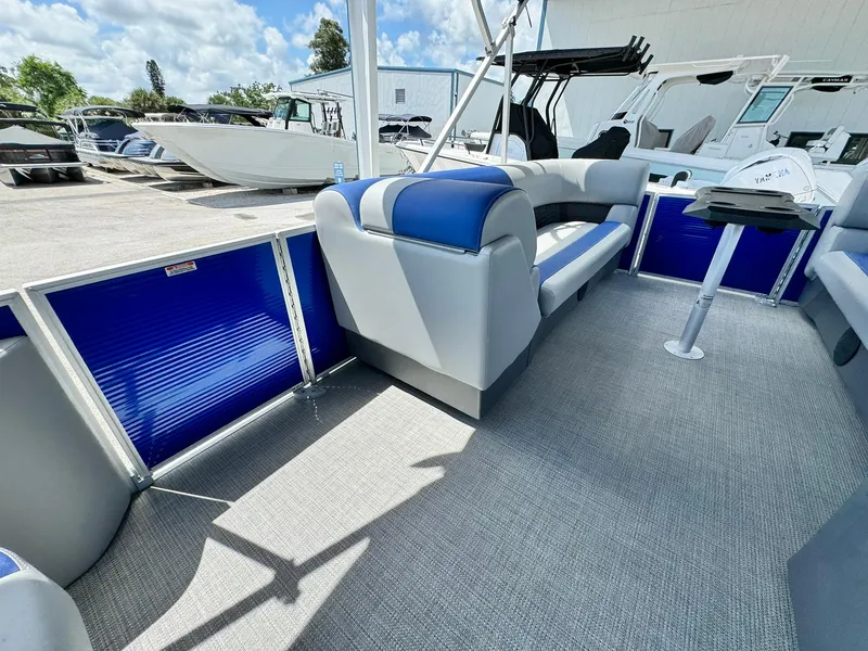 Slide: The Image of 2024 Bennington 22 SSR-SPS pontoon boat interior with blue and gray seating. - 20