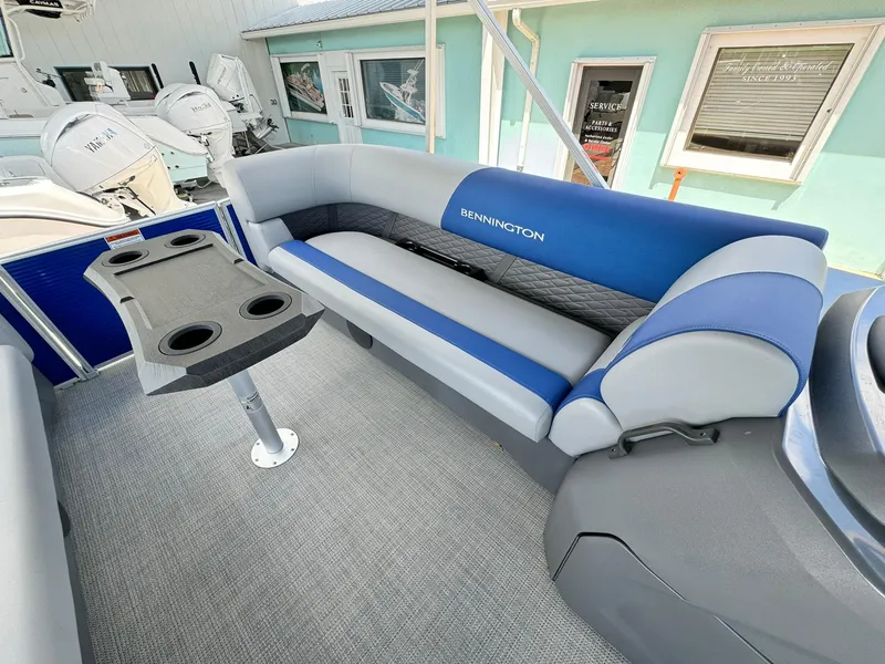 Slide: The Image of 2024 Bennington 22 SSR-SPS pontoon boat interior with blue and gray seating. - 22